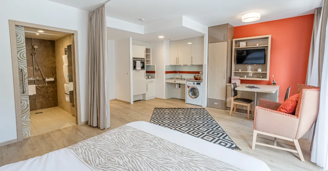 Living space: sleeping area in the foreground, kitchenette and dining nook at the back, Appart-One aparthotel, Chambéry