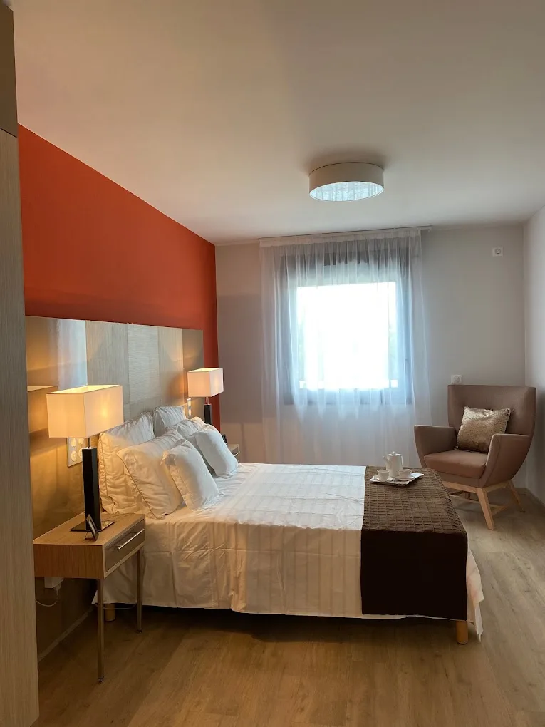 Bedroom: double bed, armchair and window, Appart-One aparthotel, Le Cannet