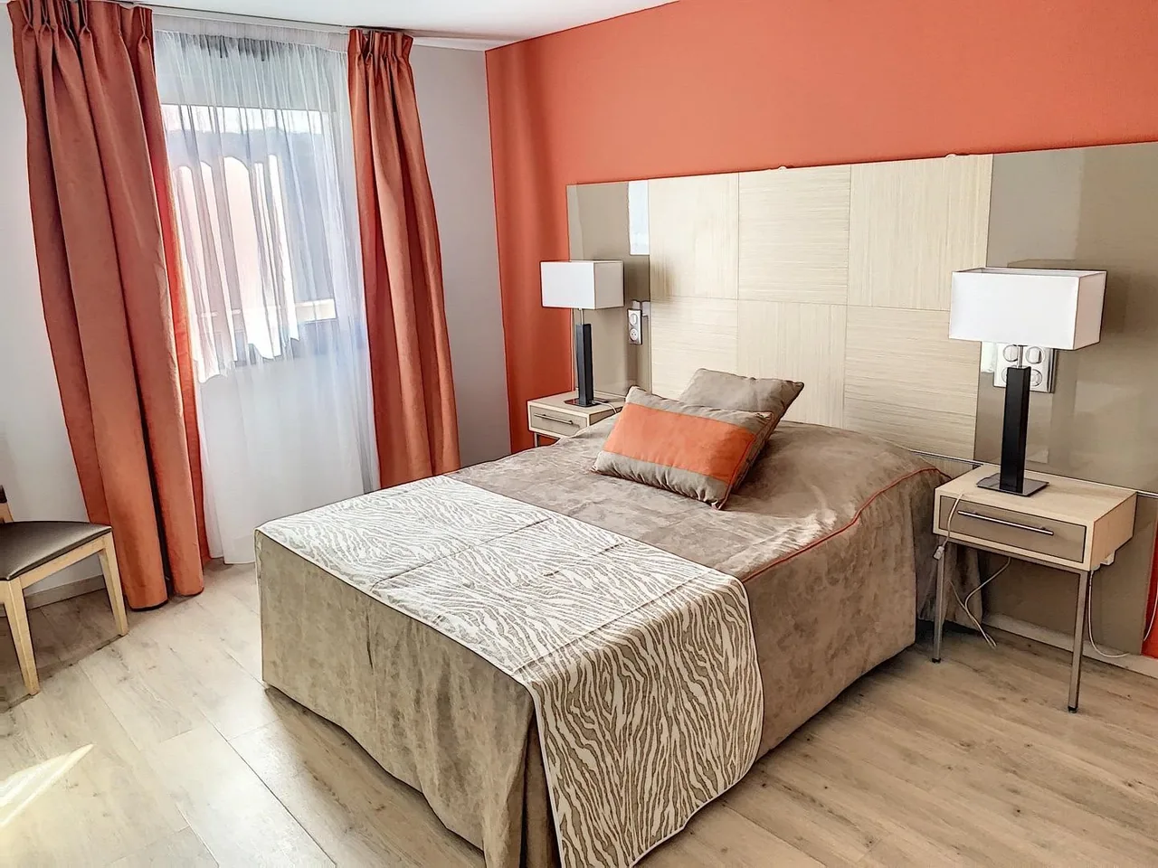 Bedroom: double bed, two bedside tables and orange curtains, Appart-One aparthotel, Le Cannet